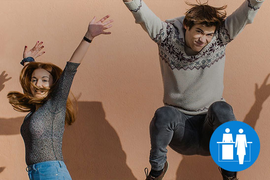 Man and woman happily jumping