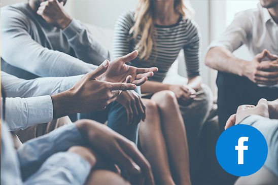 Group of people gathered sitting.